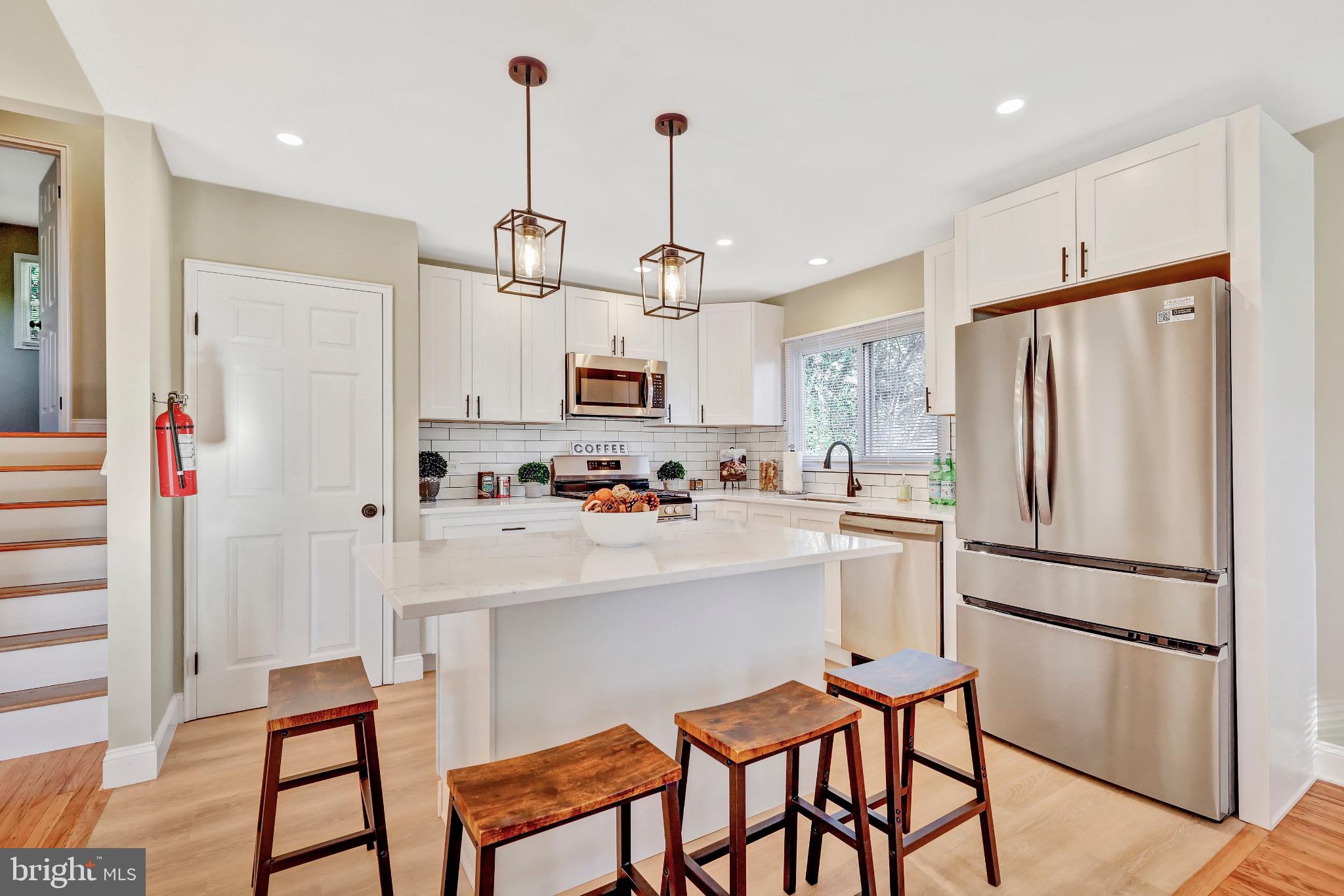 1538 Haddonfield-Berlin Road Cherry Hill, NJ 08003 - Photo 16 of 36 a kitchen with kitchen island white cabinets and stainless steel appliances