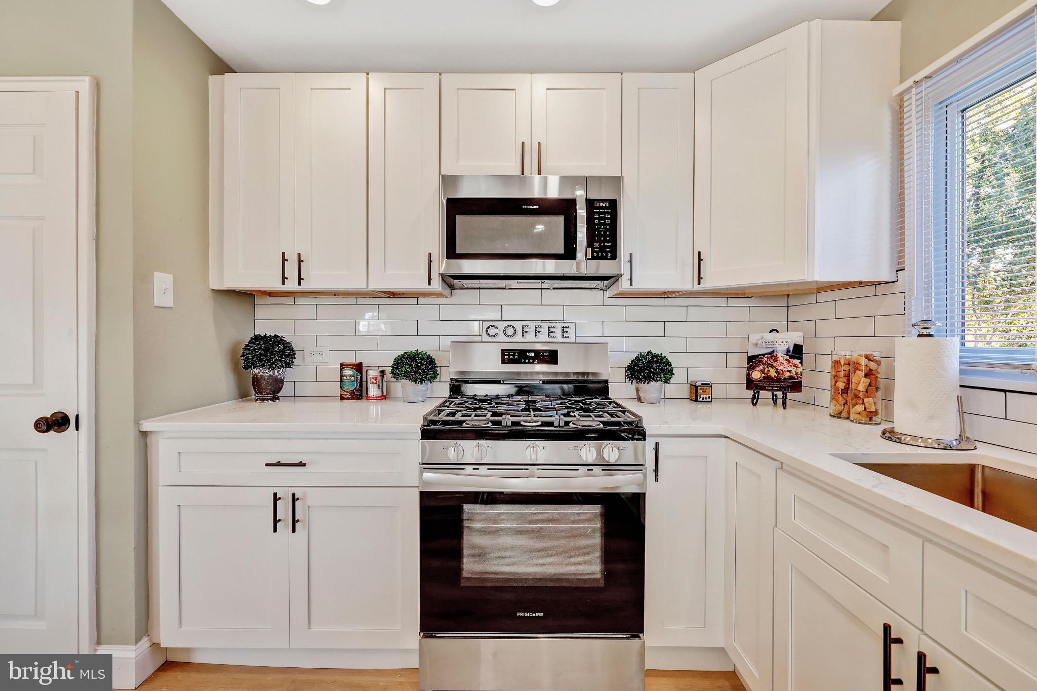 1538 Haddonfield-Berlin Road Cherry Hill, NJ 08003 - Photo 28 of 36 a kitchen with white cabinets and appliances