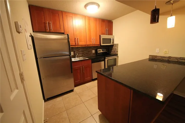 a kitchen with stainless steel appliances a refrigerator and a stove