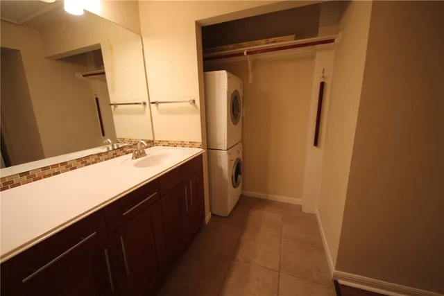 a room with a sink a washer and dryer