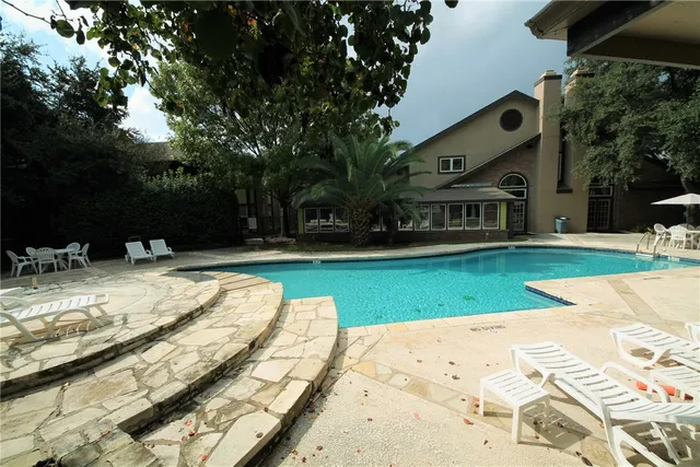 a outdoor space with a table and chairs and a barbeque