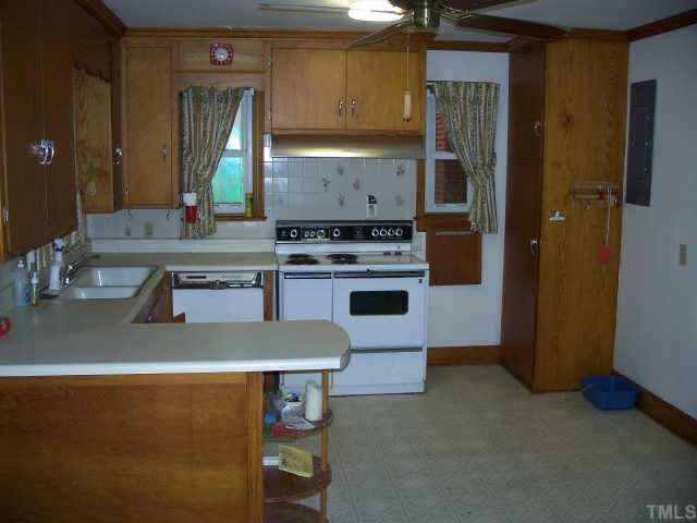 5713 North Roxboro Road Durham, NC 27712 - Photo 7 of 12 a kitchen with a sink cabinets and stainless steel appliances