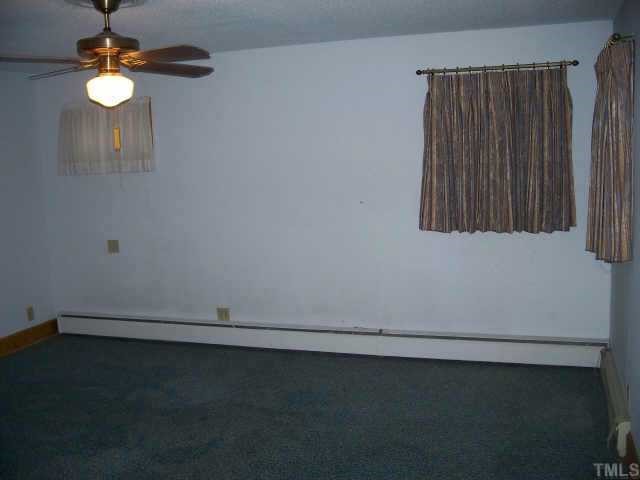 5713 North Roxboro Road Durham, NC 27712 - Photo 8 of 12 an empty room with a potted plant