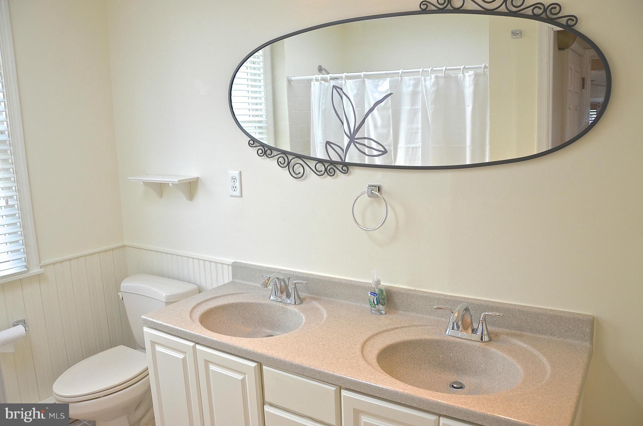 1607 Grange Road Edgewater, MD 21037 - Photo 11 of 30 a bathroom with a sink and mirror