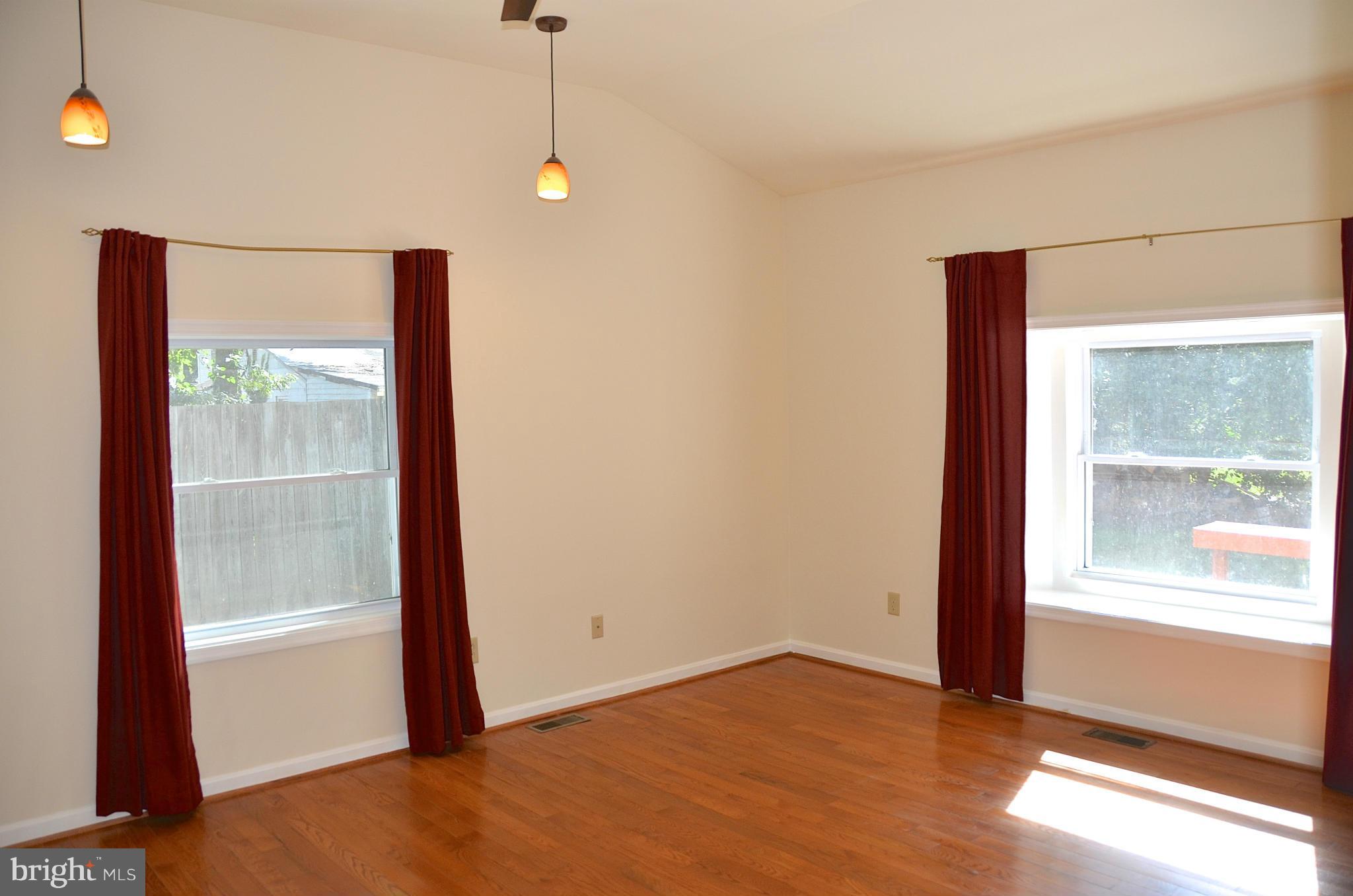 1607 Grange Road Edgewater, MD 21037 - Photo 16 of 30 a view of an empty room with wooden floor and a window