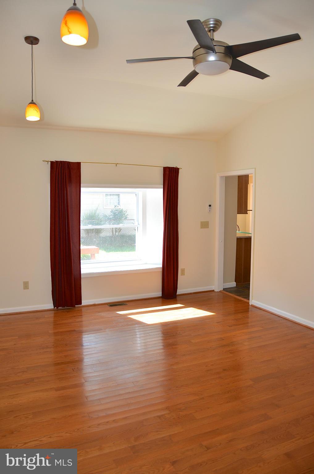 1607 Grange Road Edgewater, MD 21037 - Photo 17 of 30 a view of an empty room with window and wooden floor