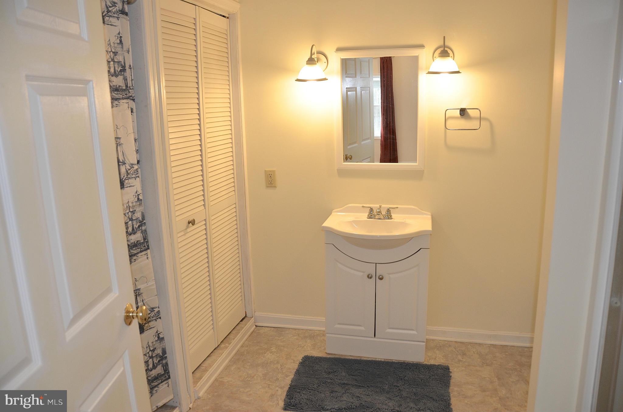 1607 Grange Road Edgewater, MD 21037 - Photo 19 of 30 a bathroom with a sink and a mirror