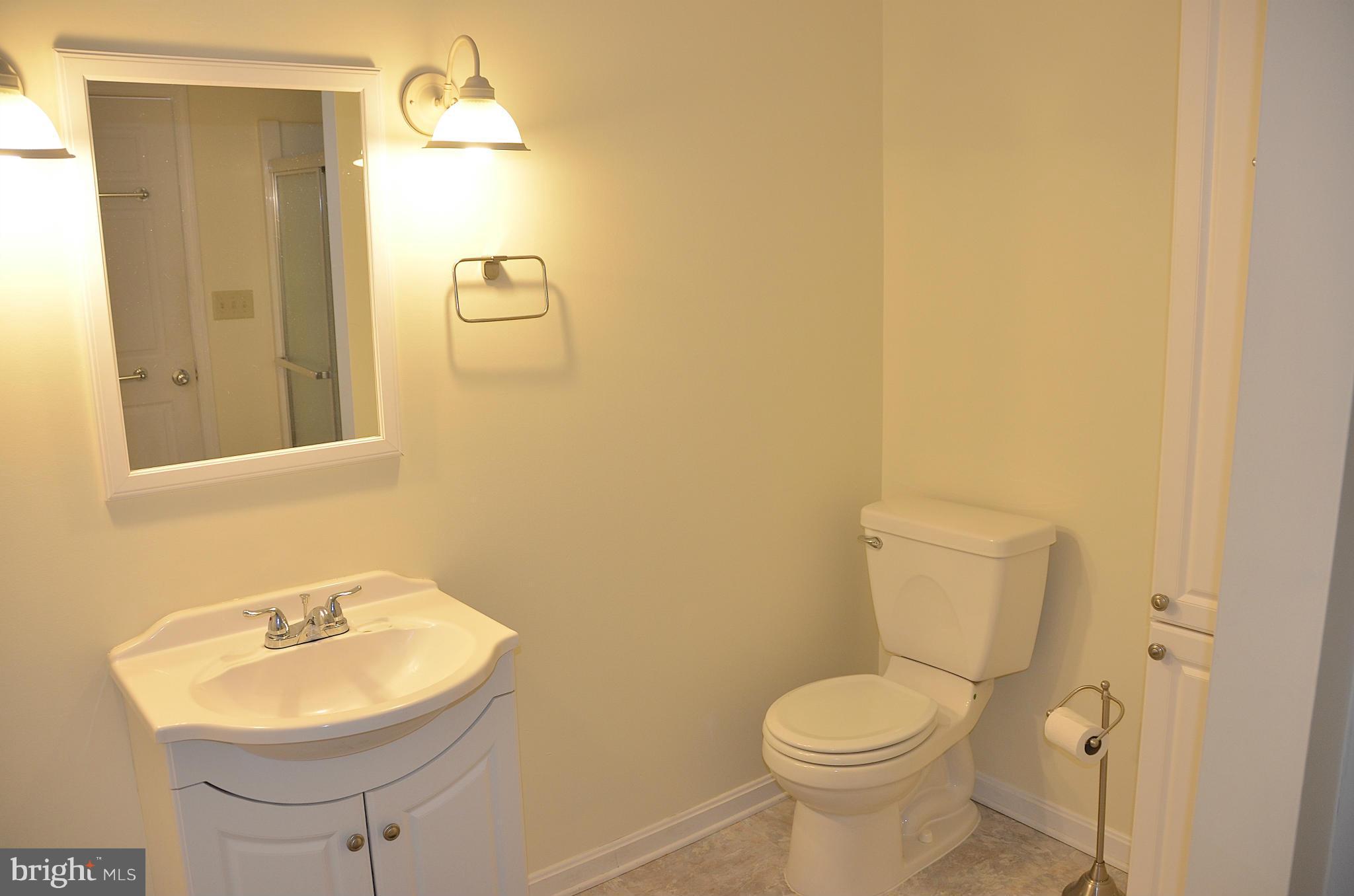 1607 Grange Road Edgewater, MD 21037 - Photo 20 of 30 a bathroom with a toilet sink and mirror