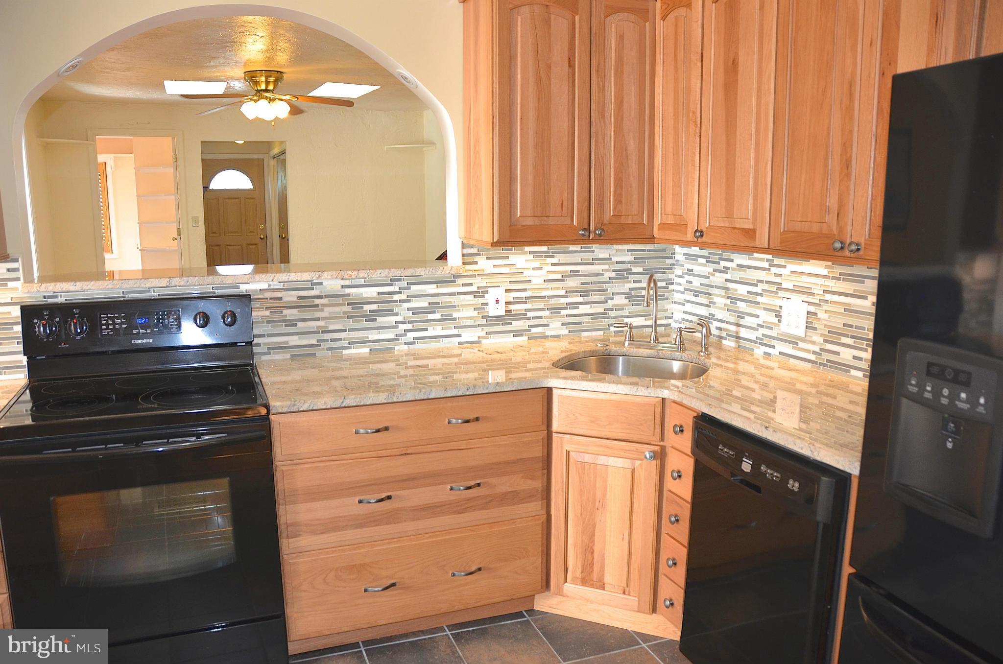 1607 Grange Road Edgewater, MD 21037 - Photo 6 of 30 a kitchen with granite countertop white cabinets and stainless steel appliances