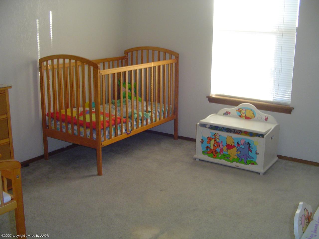 4202 Rondo Avenue Amarillo, TX 79110 - Photo 11 of 14 a bedroom with a bed and a window