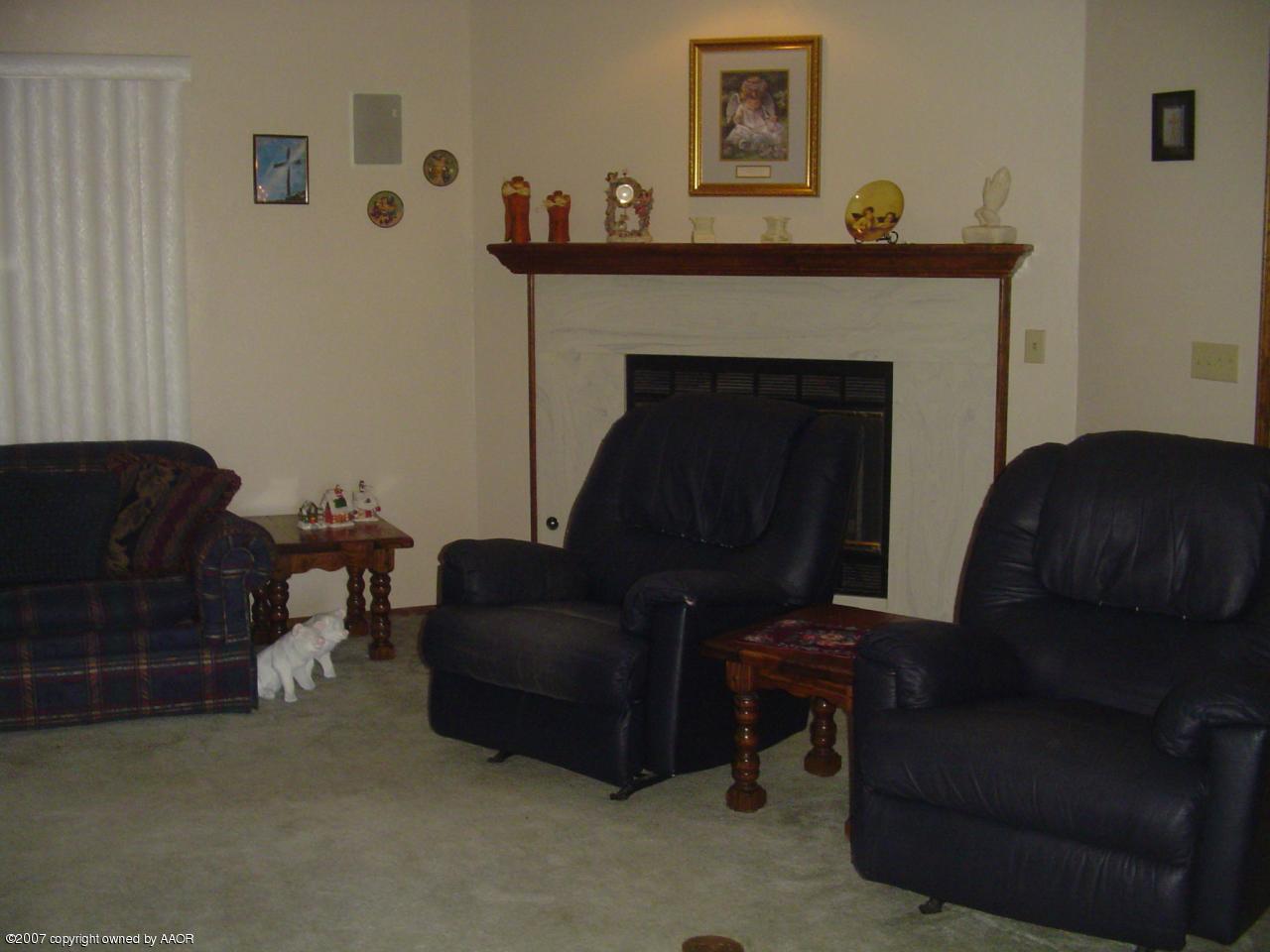 4202 Rondo Avenue Amarillo, TX 79110 - Photo 3 of 14 a living room with furniture and a fireplace