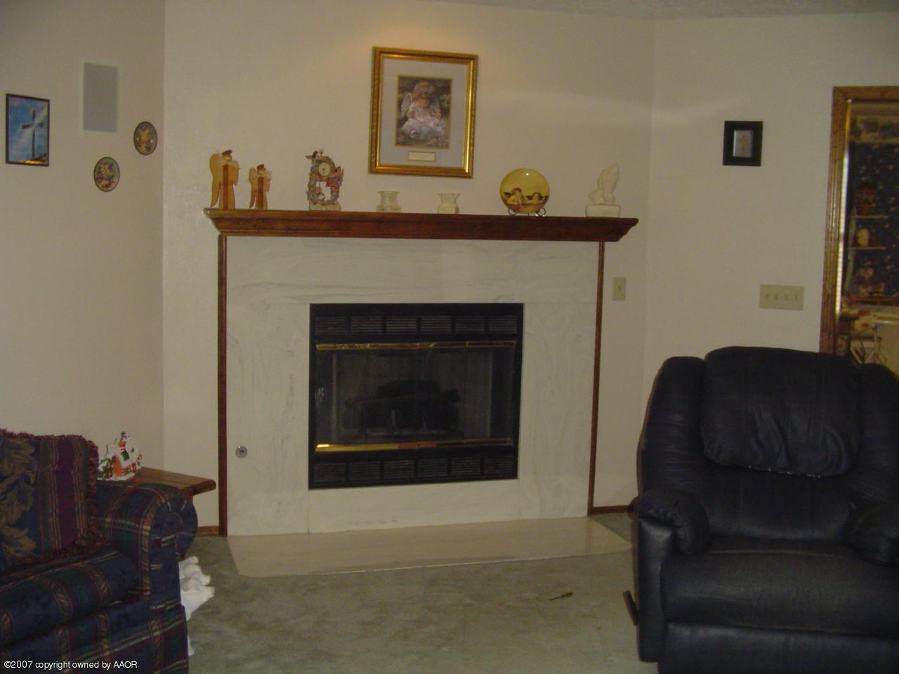 4202 Rondo Avenue Amarillo, TX 79110 - Photo 4 of 14 a living room with furniture and a fireplace