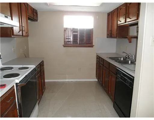 a kitchen with a sink stove and refrigerator