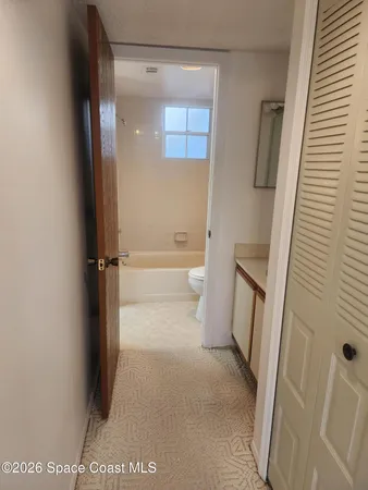 a view of an empty room with a fan