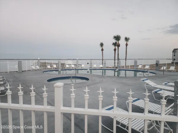 swimming pool view with a seating space