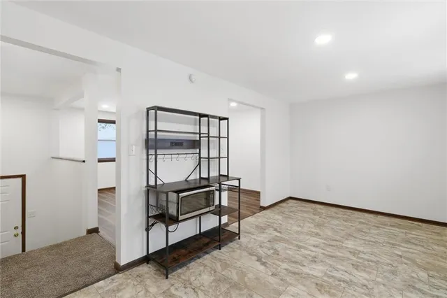 a view of room with stairs and wooden floor
