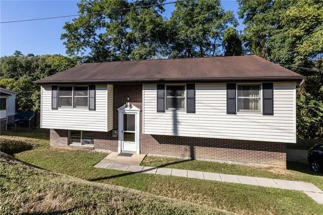 a front view of a house with a yard