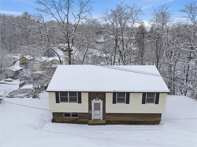 a front view of a house with white wall