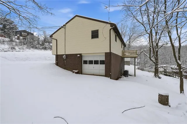 a view of a patio with table and chairs with wooden fence and plants