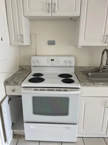a stove top oven sitting inside of a kitchen