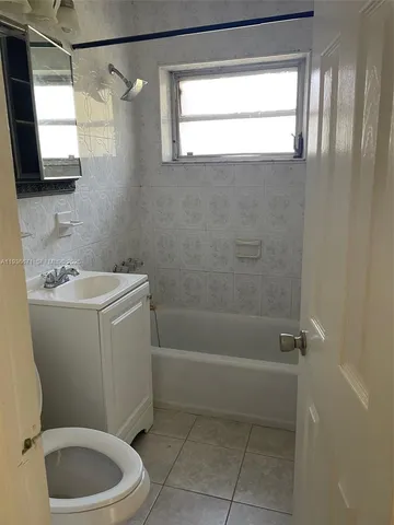 a bathroom with a sink a toilet and a shower