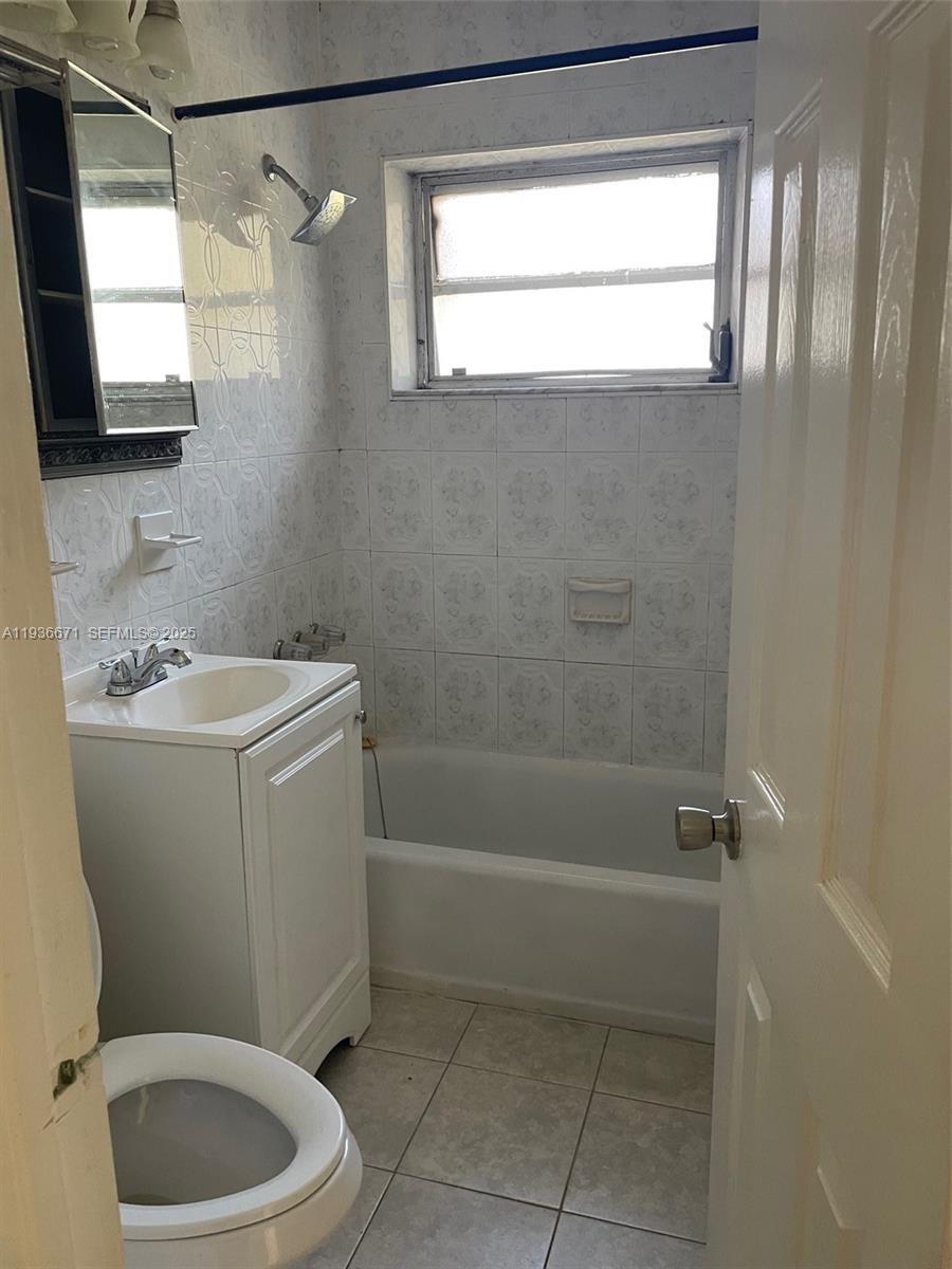 115 Virginia Road, Unit 115 Hollywood, FL 33023 - Photo 10 of 12 a bathroom with a sink a toilet and a shower