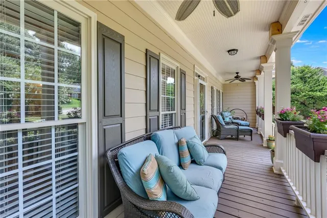 a kitchen with stainless steel appliances granite countertop a stove top oven a sink dishwasher a refrigerator and a dining table with wooden floor