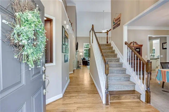 a bed sitting in a spacious bedroom next to a window
