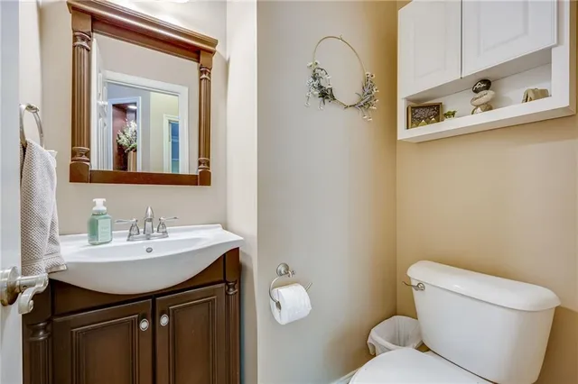 an aerial view of a residential houses with outdoor space and trees all around