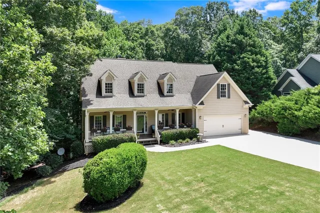 an aerial view of a house with yard swimming pool and outdoor seating