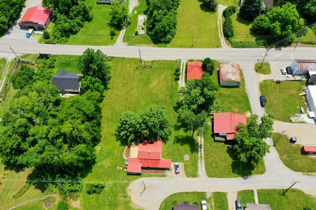 an aerial view of a house swimming pool a patio and outdoor seating