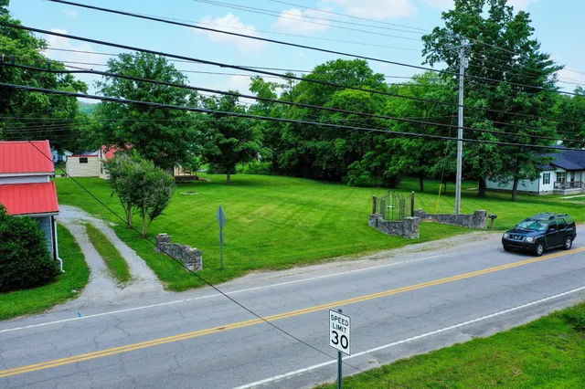 an aerial view of a tennis ground and a yard
