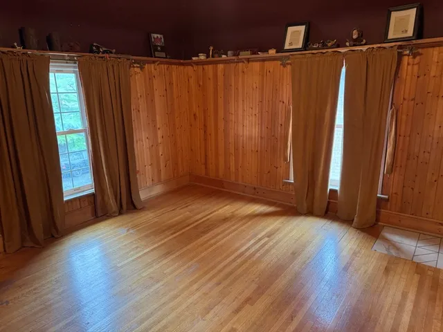 a view of a room with wooden floor
