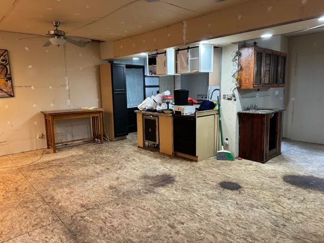a kitchen with a sink and a stove top oven