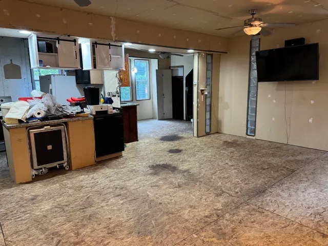 a kitchen with stainless steel appliances kitchen island granite countertop a stove top oven a sink and a refrigerator