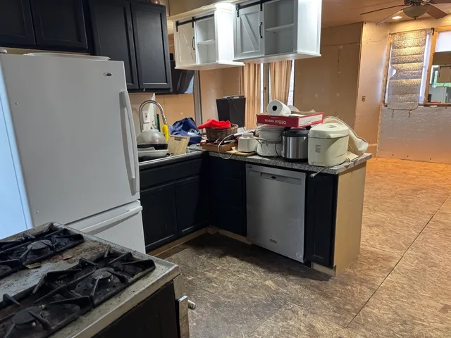 a kitchen with stainless steel appliances granite countertop a stove and a refrigerator
