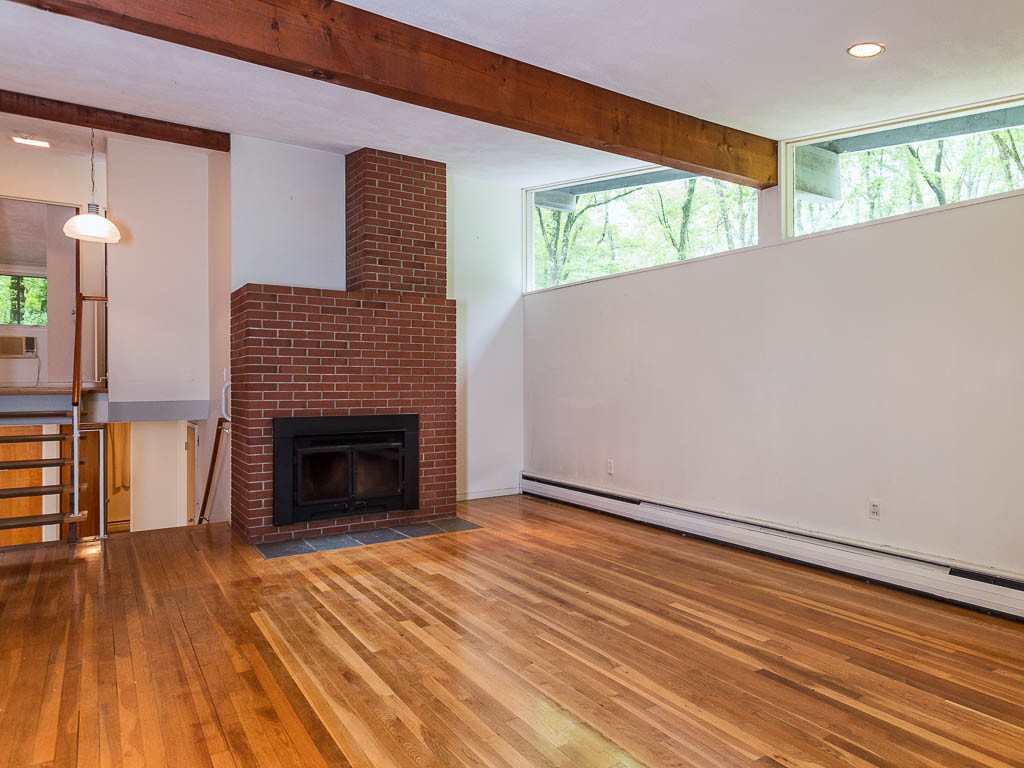 62 Turning Mill Road Lexington, MA 02420 - Photo 4 of 12 a view of an empty room with wooden floor and a window