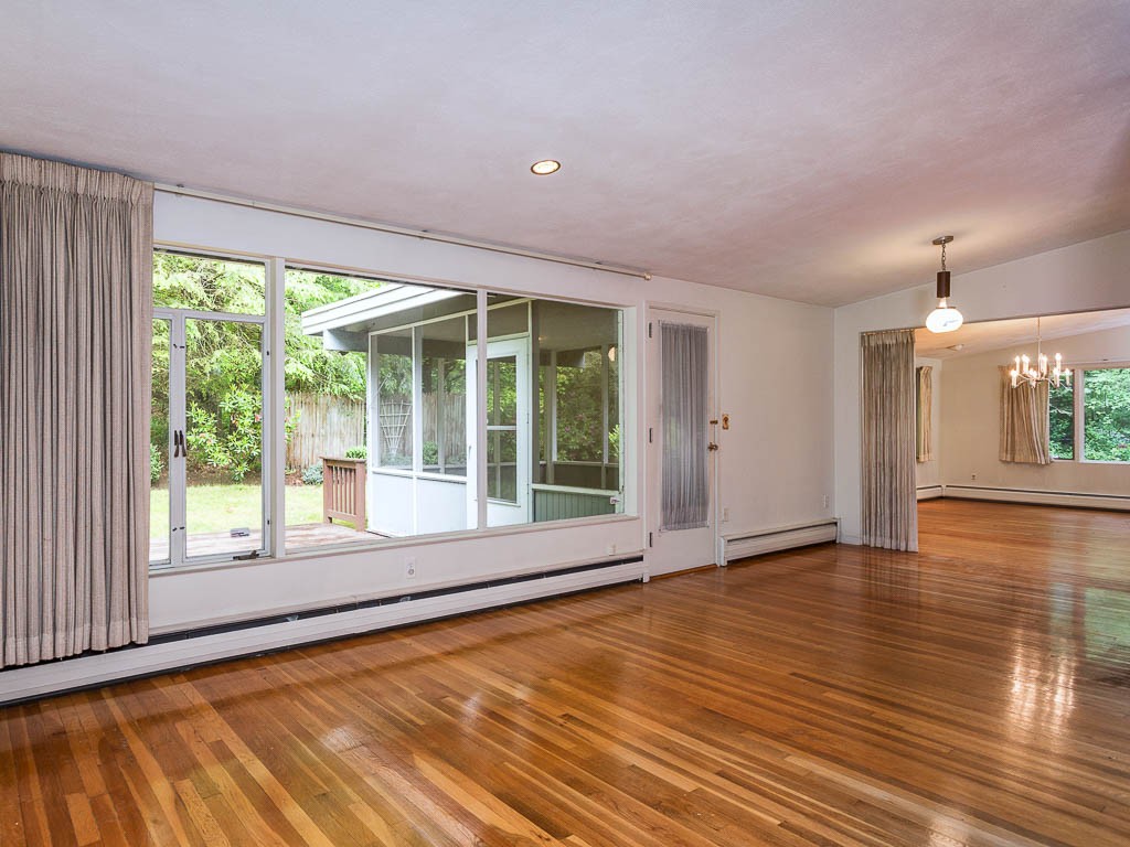 62 Turning Mill Road Lexington, MA 02420 - Photo 5 of 12 a view of an empty room with wooden floor and a window