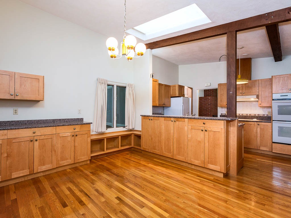 62 Turning Mill Road Lexington, MA 02420 - Photo 6 of 12 a large kitchen with stainless steel appliances wooden floor and a large window
