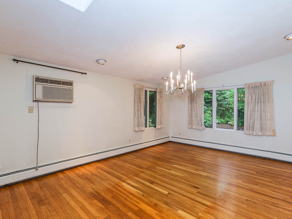 62 Turning Mill Road Lexington, MA 02420 - Photo 8 of 12 a view of an empty room with wooden floor and a window