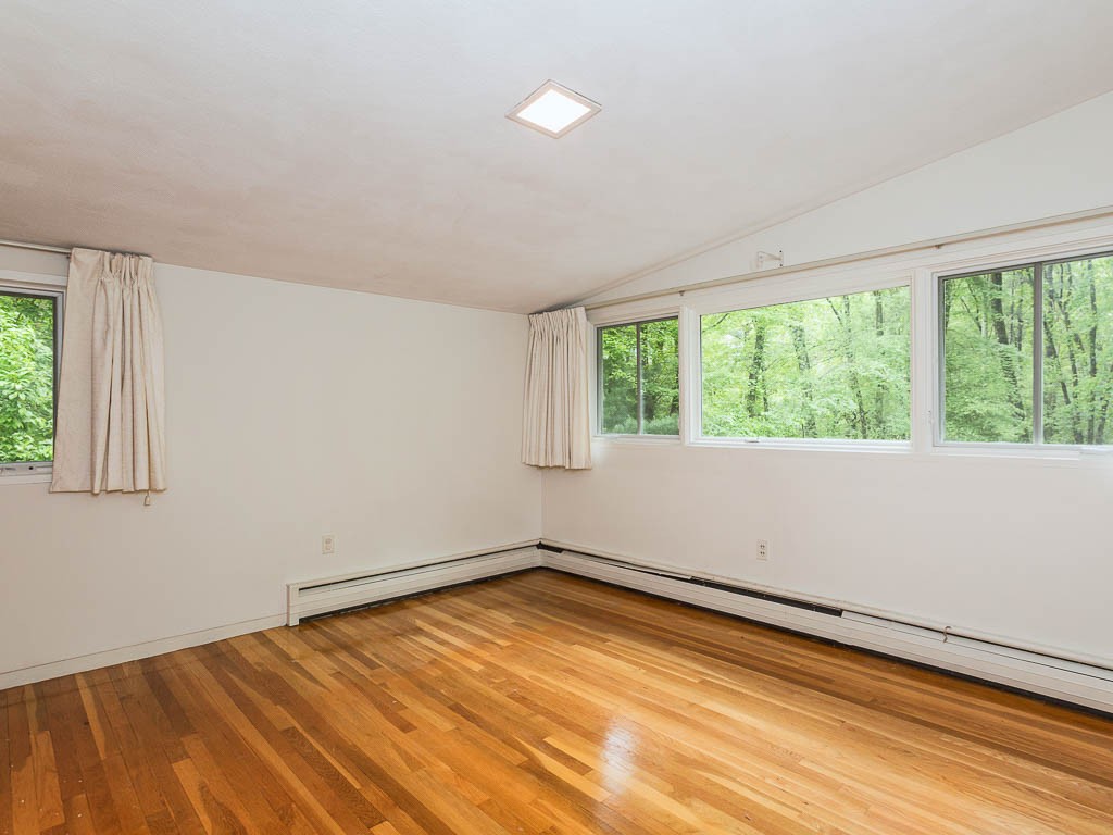 62 Turning Mill Road Lexington, MA 02420 - Photo 10 of 12 a view of empty room with wooden floor and fan