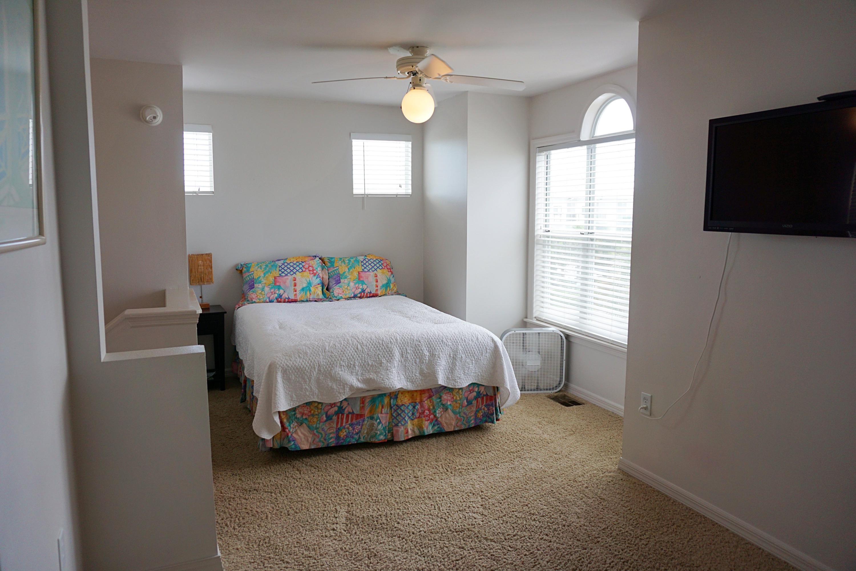 4944 West Co Highway Santa Rosa Beach, FL 32459 - Photo 18 of 24 a bedroom with a bed and a flat screen tv