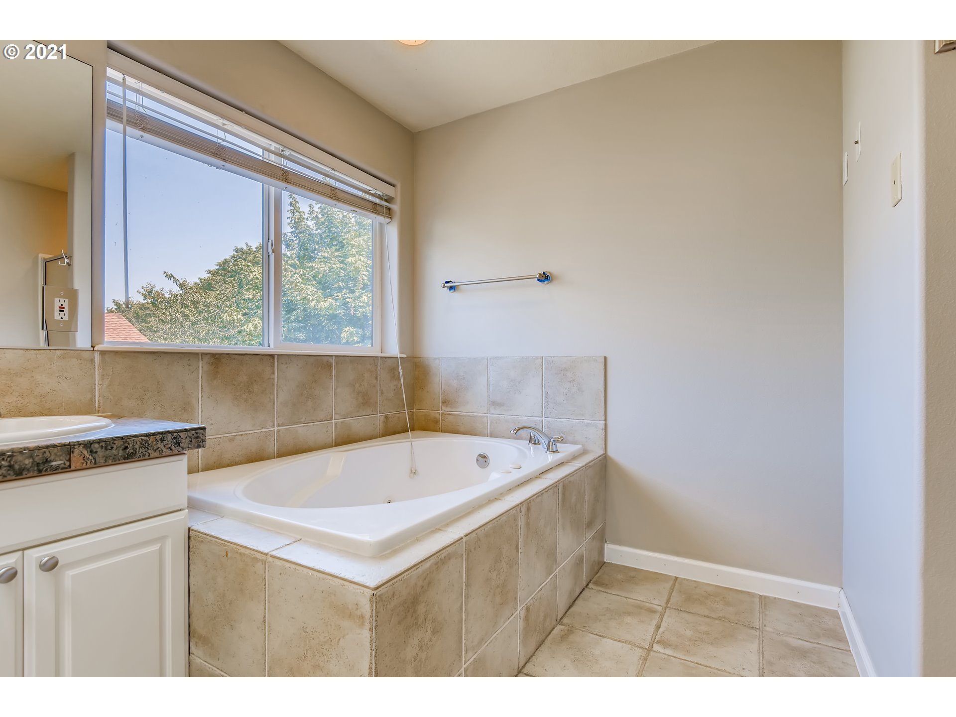 16123 Southeast Rural Court Portland, OR 97236 - Photo 22 of 32 a bathroom with a sink a bathtub and a window