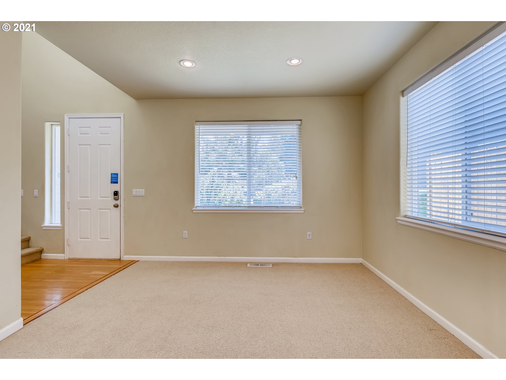 16123 Southeast Rural Court Portland, OR 97236 - Photo 4 of 32 an empty room with wooden floor and windows