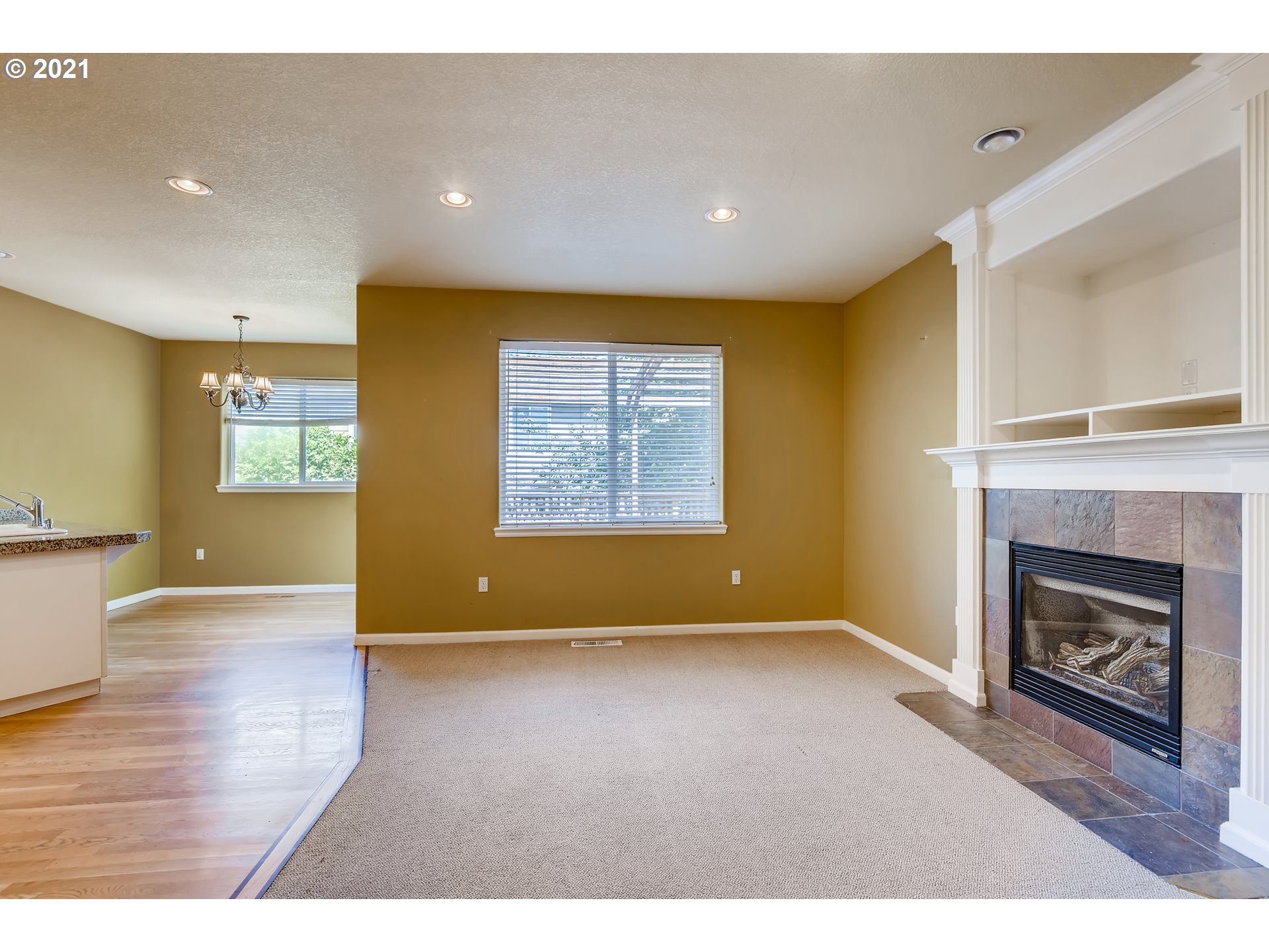 16123 Southeast Rural Court Portland, OR 97236 - Photo 5 of 32 a view of an empty room with a fireplace and a window
