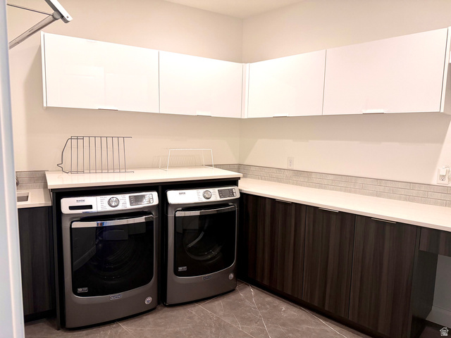 1500 Split Rock, Unit 150 Ivins, UT 84738 - Photo 14 of 18 Laundry area featuring white upper cabinetry, dark wood-finish lower cabinetry, white countertops, and a gray tile backsplash