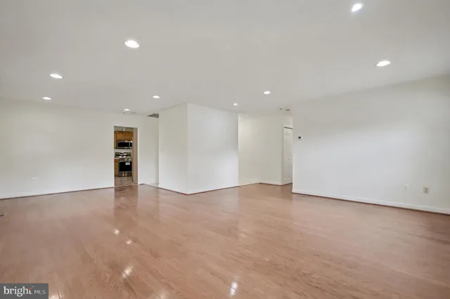 a view of an empty room with a kitchen