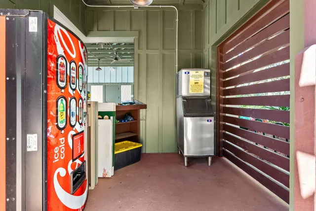 a view of a patio with table and chairs potted plants with wooden floor and floor to ceiling window
