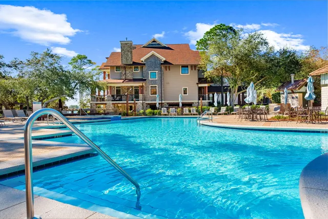 a view of a house with swimming pool and sitting area