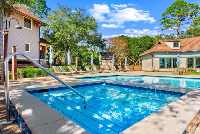 a view of residential houses with yard and swimming pool